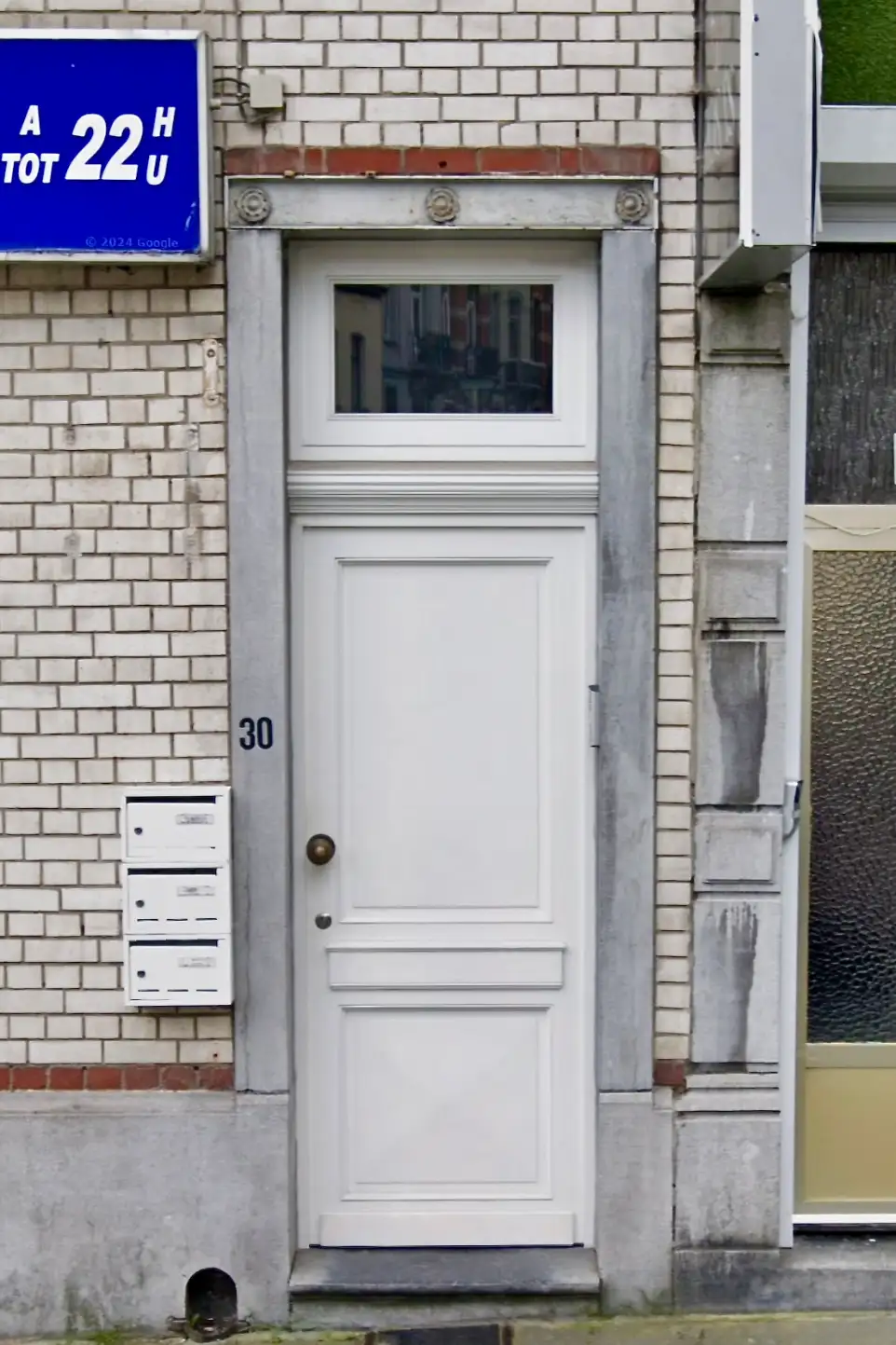 Porte d'entrée blanche moulurée avec panneau en diamant et imposte